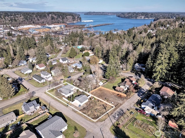 aerial view featuring a water view and a wooded view