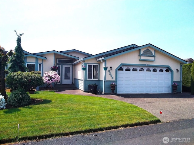 ranch-style home with aphalt driveway, a front yard, and an attached garage