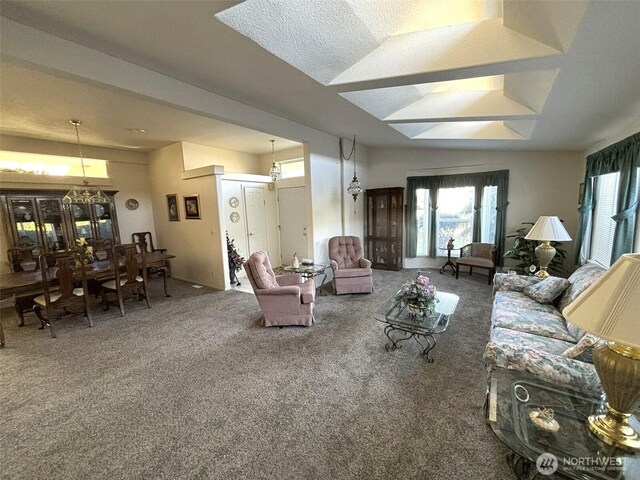 living room featuring carpet and an inviting chandelier