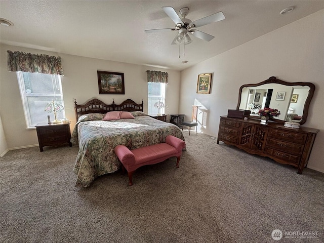 bedroom featuring multiple windows, lofted ceiling, ceiling fan, and carpet flooring