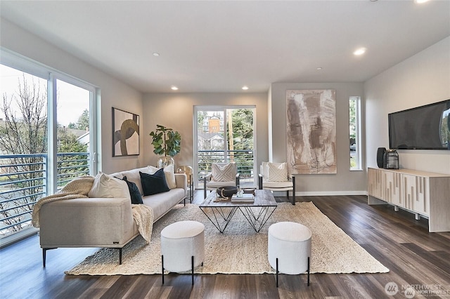 living room featuring recessed lighting, dark wood-type flooring, and baseboards