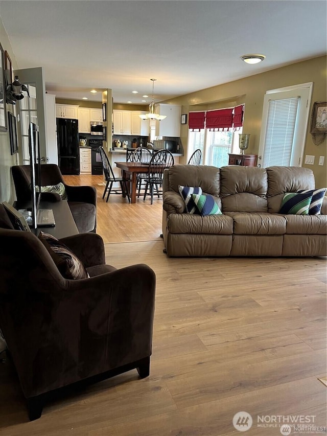 living area featuring recessed lighting and light wood finished floors