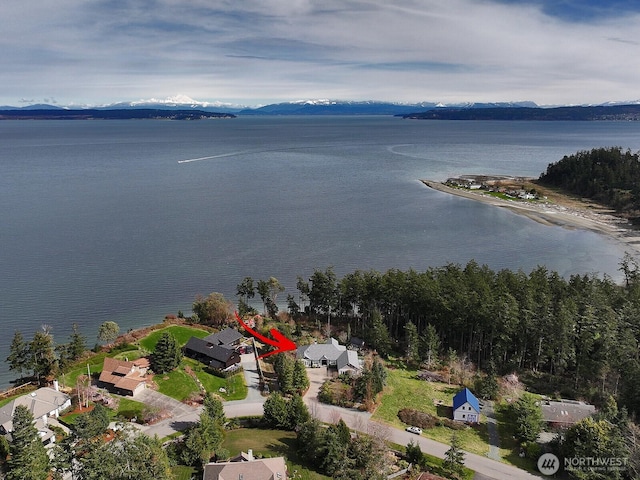drone / aerial view featuring a water and mountain view