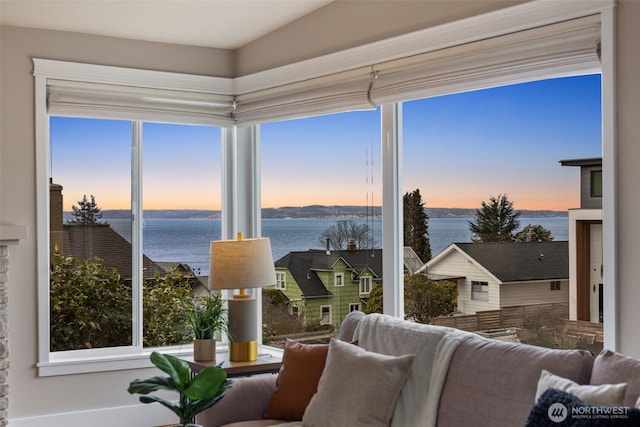 sunroom featuring a water view and a wealth of natural light