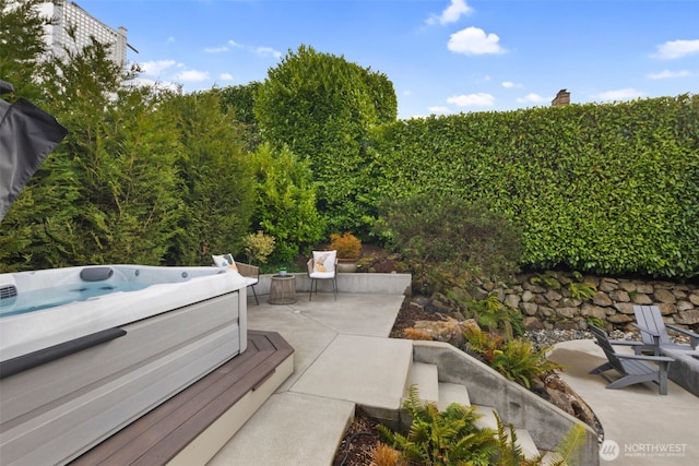 view of patio / terrace with a hot tub