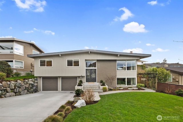 view of front of property with a garage, concrete driveway, a front lawn, and fence