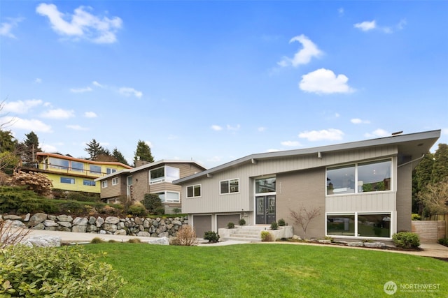 view of front of house with a garage and a front yard