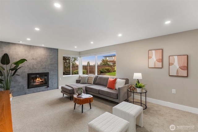 living area featuring recessed lighting, light colored carpet, a fireplace, and baseboards