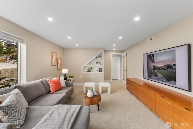 living room featuring baseboards, recessed lighting, visible vents, and light colored carpet