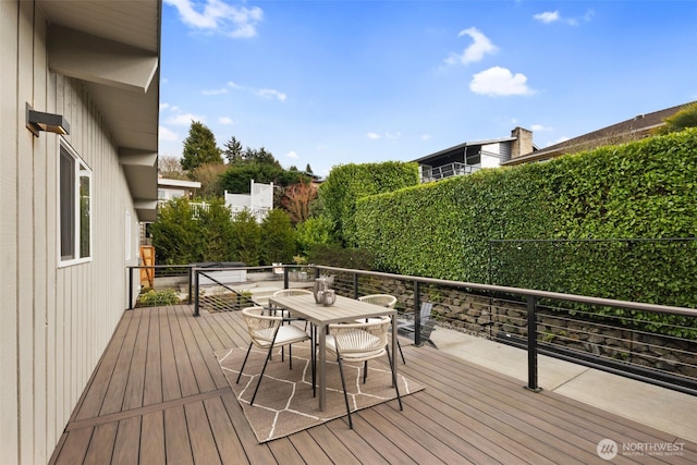 wooden terrace with outdoor dining area