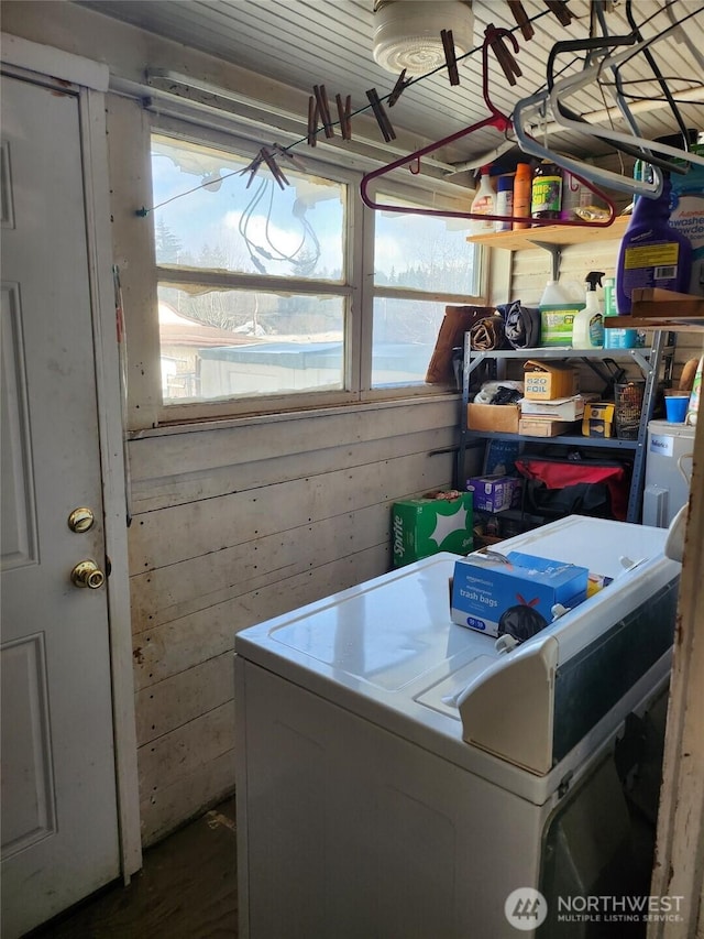 clothes washing area with laundry area and wooden walls