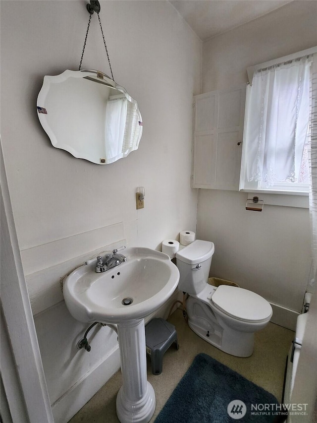 half bathroom with toilet and a sink