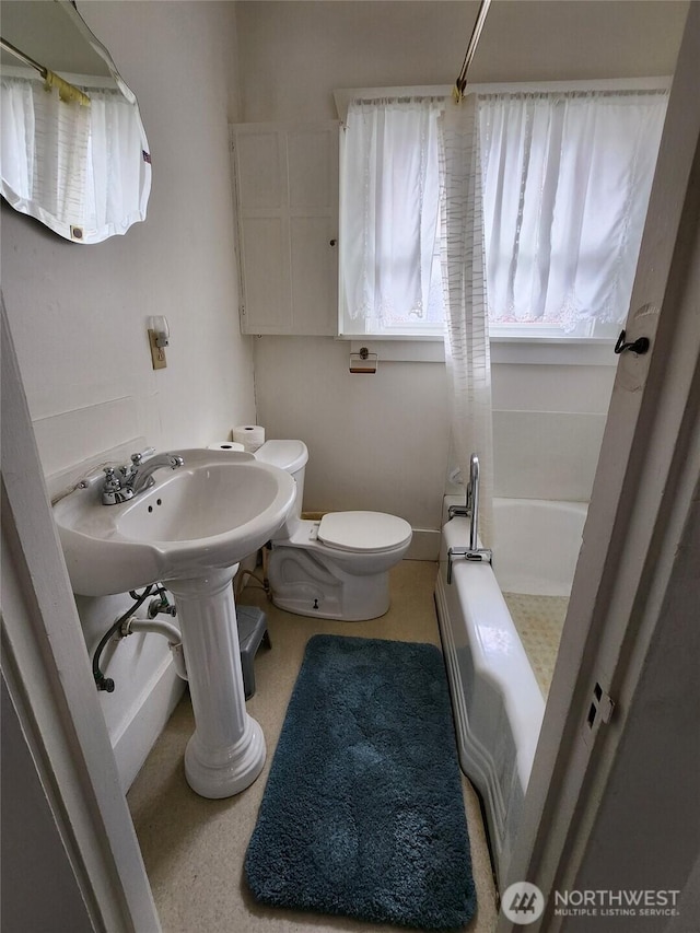 bathroom with shower / bathtub combination and toilet