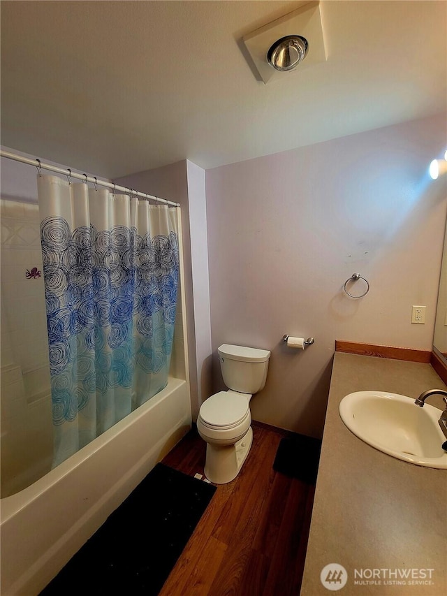 full bathroom with shower / bath combination with curtain, vanity, toilet, and wood finished floors