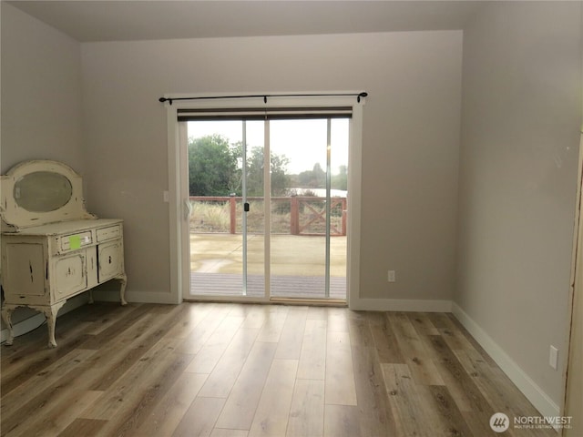 interior space featuring baseboards and light wood-style flooring