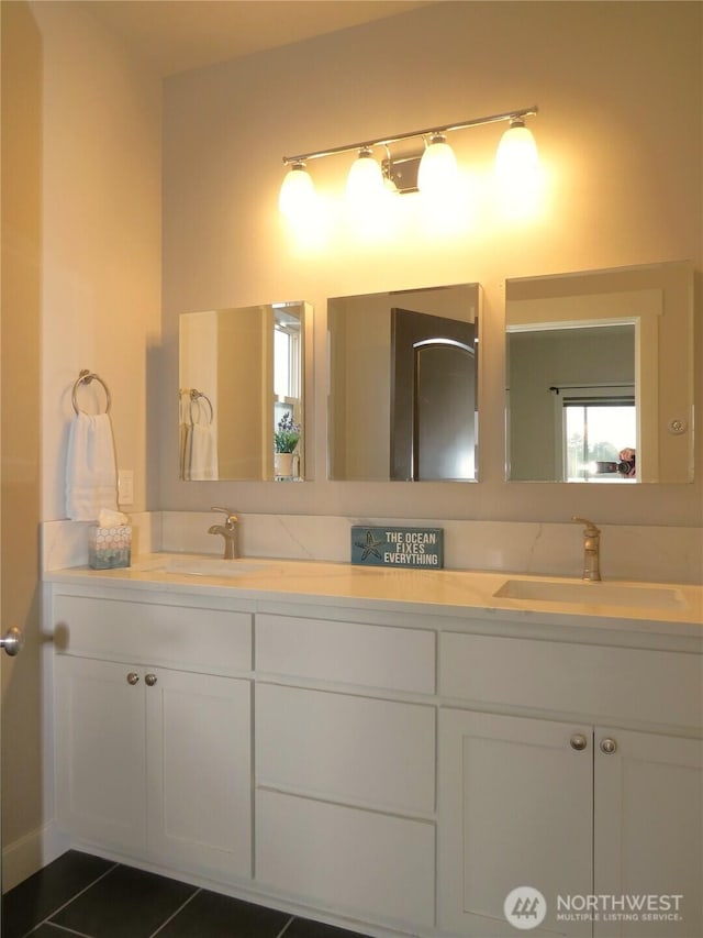 bathroom featuring double vanity, tile patterned floors, and a sink