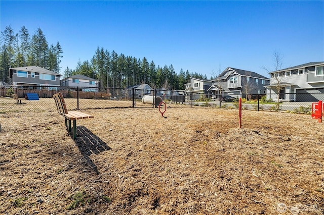 view of yard featuring a residential view and fence