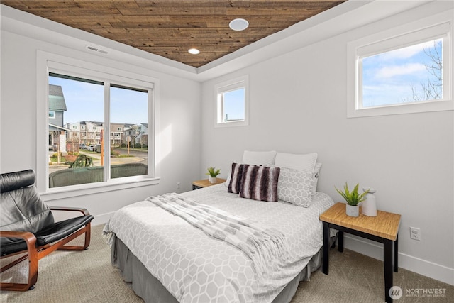 bedroom with wood ceiling, visible vents, baseboards, and light colored carpet