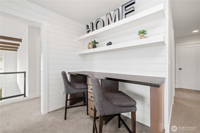 office featuring recessed lighting, carpet flooring, and wooden walls