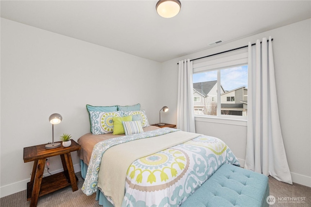 bedroom with carpet floors, baseboards, and visible vents