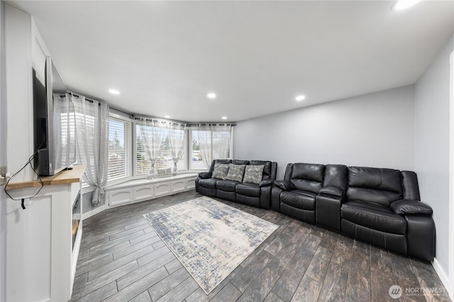 living area with baseboards, dark wood finished floors, and recessed lighting