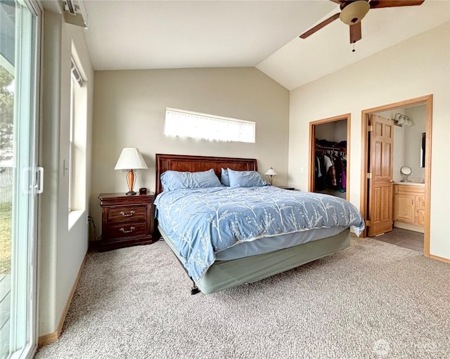 bedroom with carpet floors, a ceiling fan, vaulted ceiling, a closet, and a walk in closet