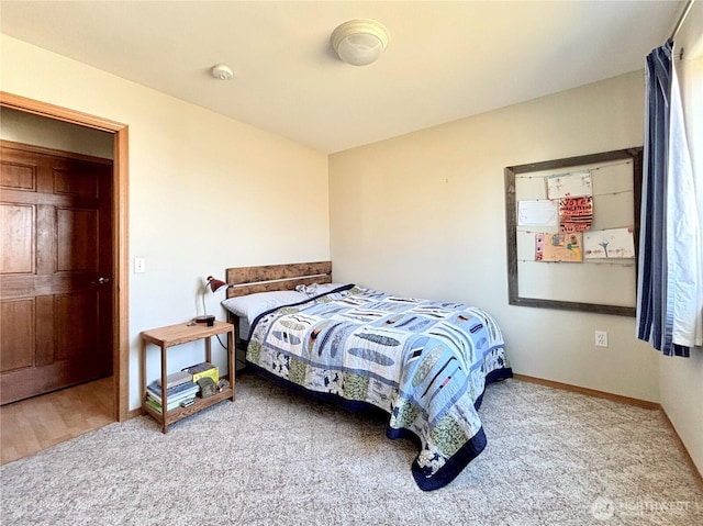 bedroom with carpet and baseboards