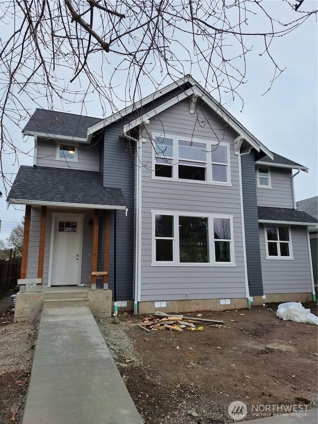 view of front facade with crawl space and roof with shingles