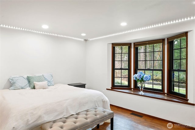 bedroom with visible vents, wood finished floors, and recessed lighting