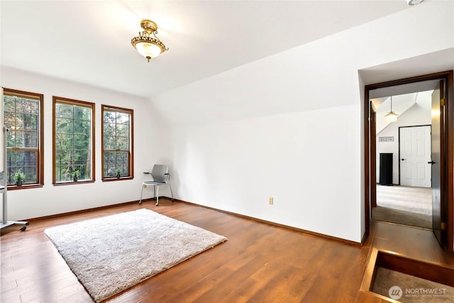 bonus room with vaulted ceiling, baseboards, and wood finished floors