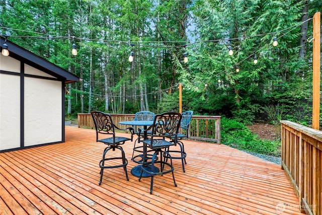 wooden deck with outdoor dining area