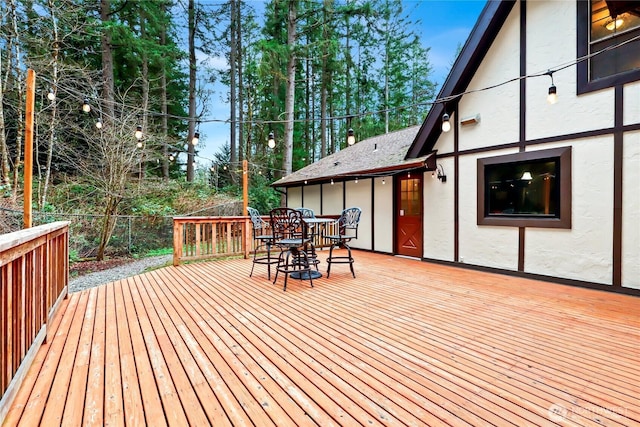 wooden deck featuring outdoor dining area and fence