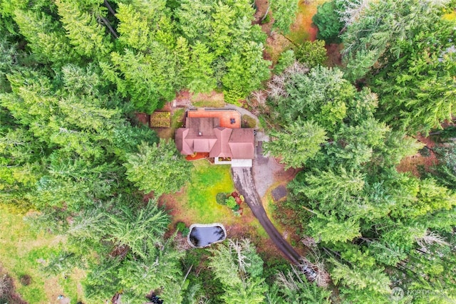 birds eye view of property featuring a view of trees