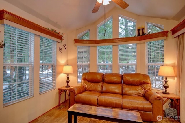 living room with vaulted ceiling, light wood finished floors, and a ceiling fan