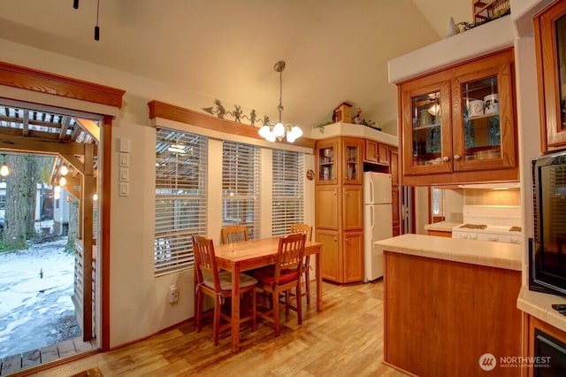 dining space with a chandelier and light wood-type flooring