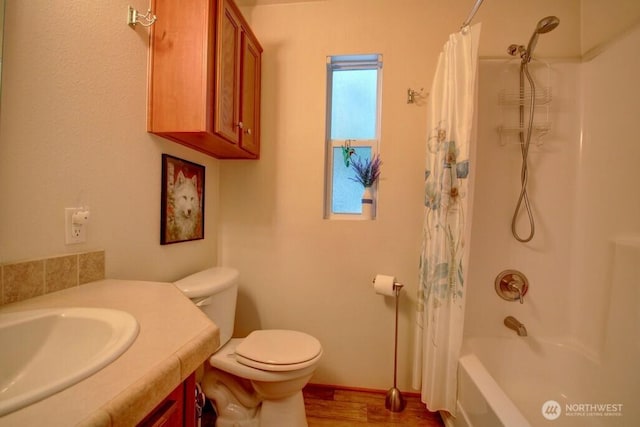 full bathroom featuring toilet, shower / tub combo with curtain, wood finished floors, and vanity