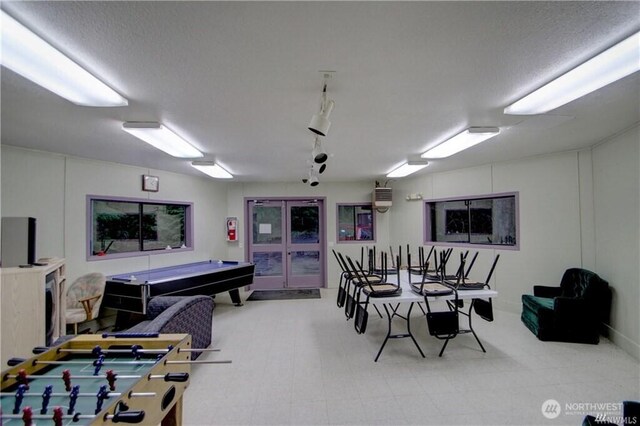 playroom with a textured ceiling