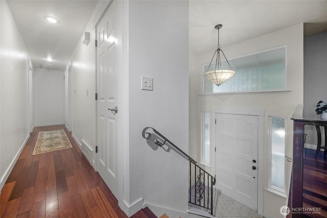 foyer featuring visible vents, baseboards, and wood finished floors