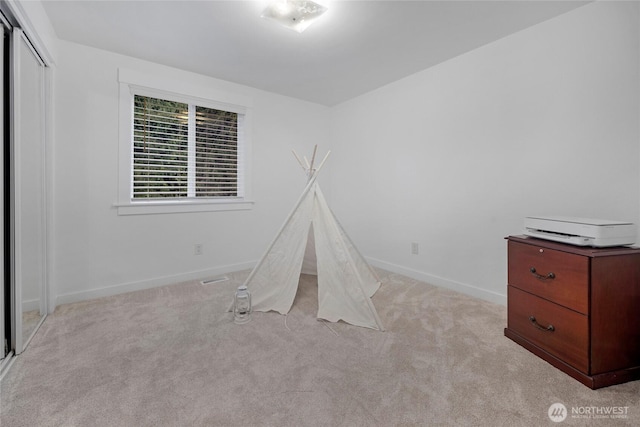 game room featuring baseboards and light colored carpet