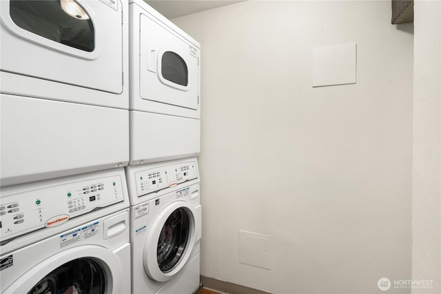 washroom with laundry area, washer and clothes dryer, and stacked washing maching and dryer