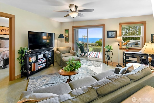 living room featuring a ceiling fan and baseboards