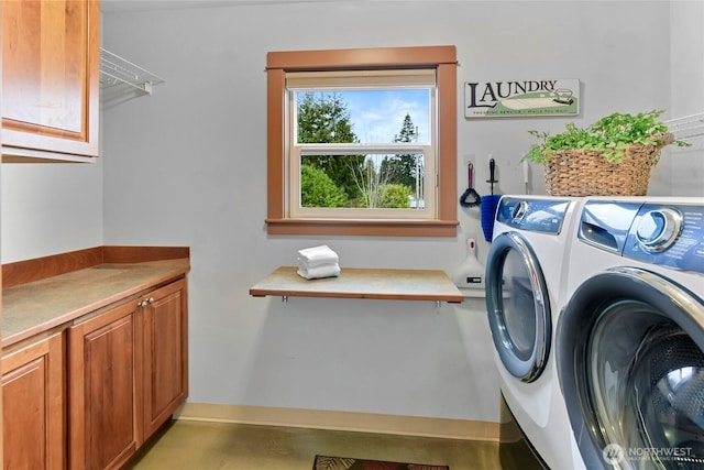 washroom with cabinet space and independent washer and dryer