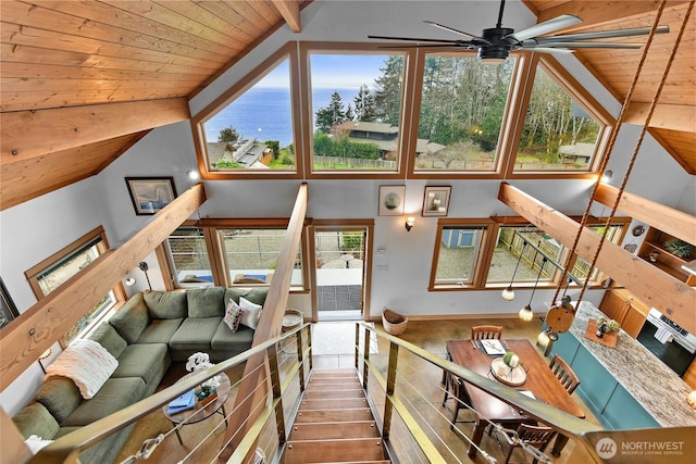 living area featuring wooden ceiling, ceiling fan, and high vaulted ceiling