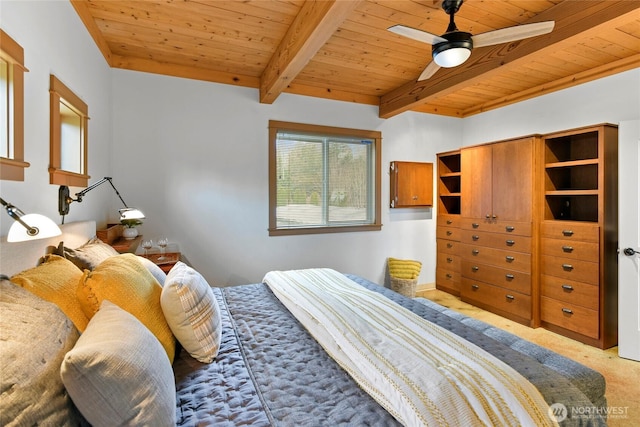 bedroom with ceiling fan, beamed ceiling, wooden ceiling, and light carpet