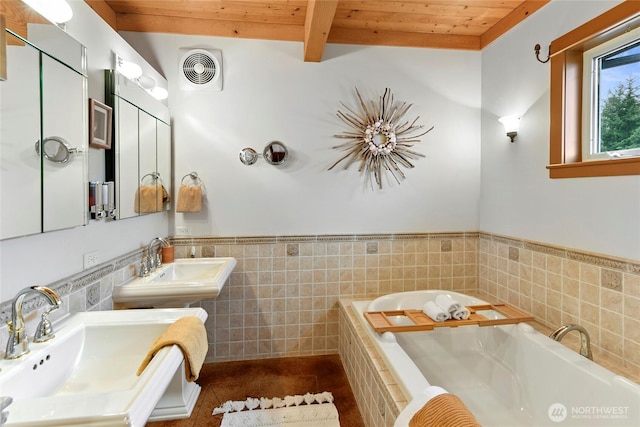 full bath with visible vents, beam ceiling, a sink, and wood ceiling