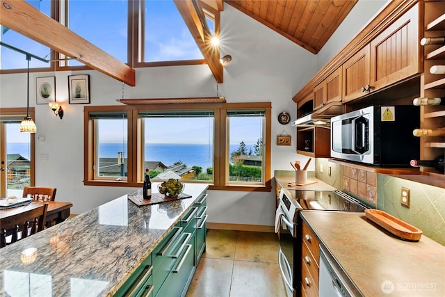 kitchen with a water view, a wealth of natural light, stainless steel appliances, and backsplash