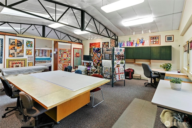 carpeted office space featuring lofted ceiling and built in study area