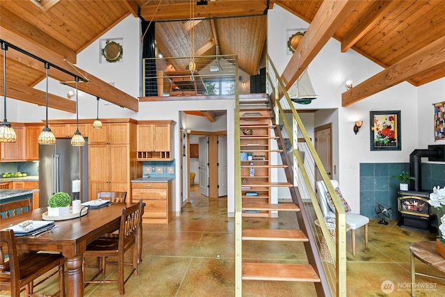 staircase with a wood stove, wood ceiling, high vaulted ceiling, and beamed ceiling