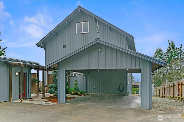 back of property with a garage and fence