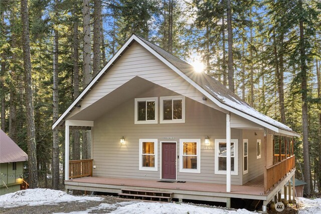 snow covered property featuring a wooden deck